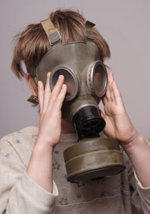 Boy in gas mask to protect from dragon breath