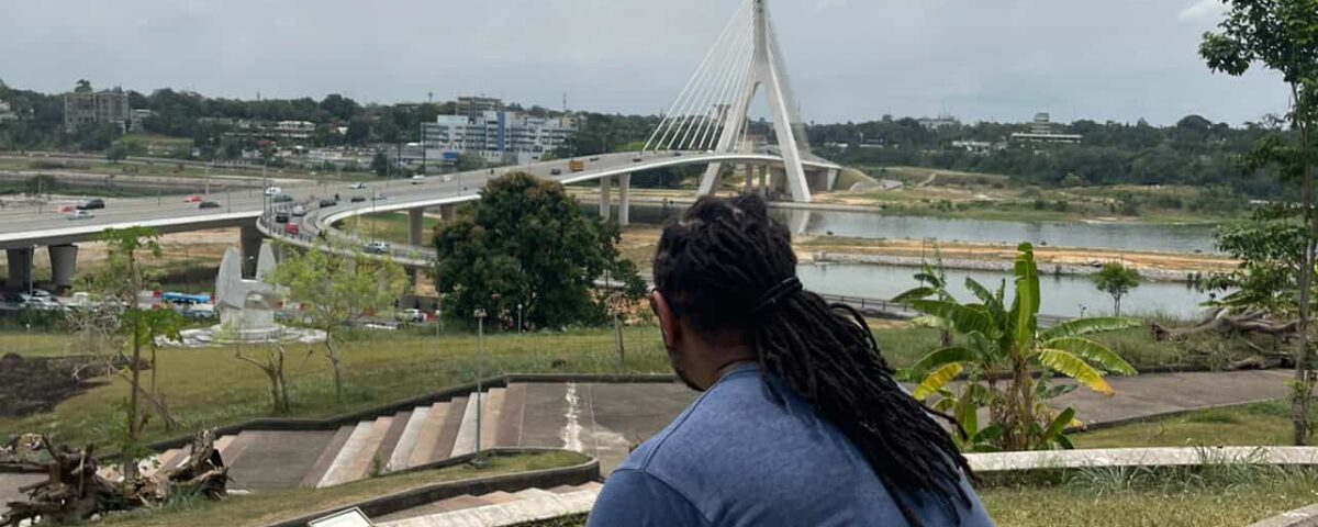 Traveler sitting and overlooking the city of Abidjan from St. Paul’s Cathedral