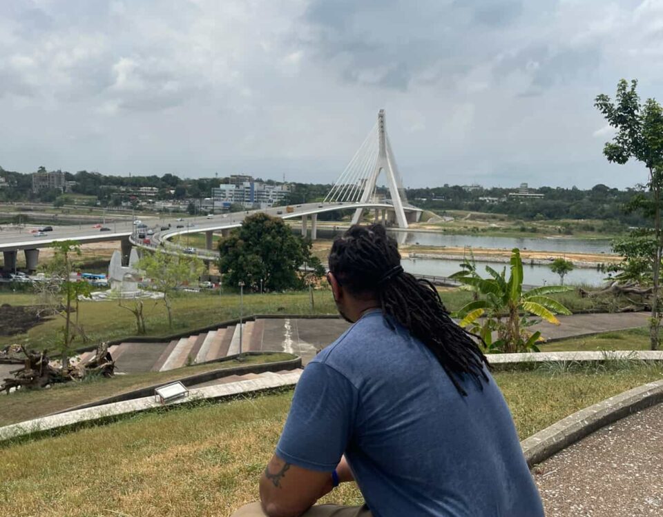 Traveler sitting and overlooking the city of Abidjan from St. Paul’s Cathedral